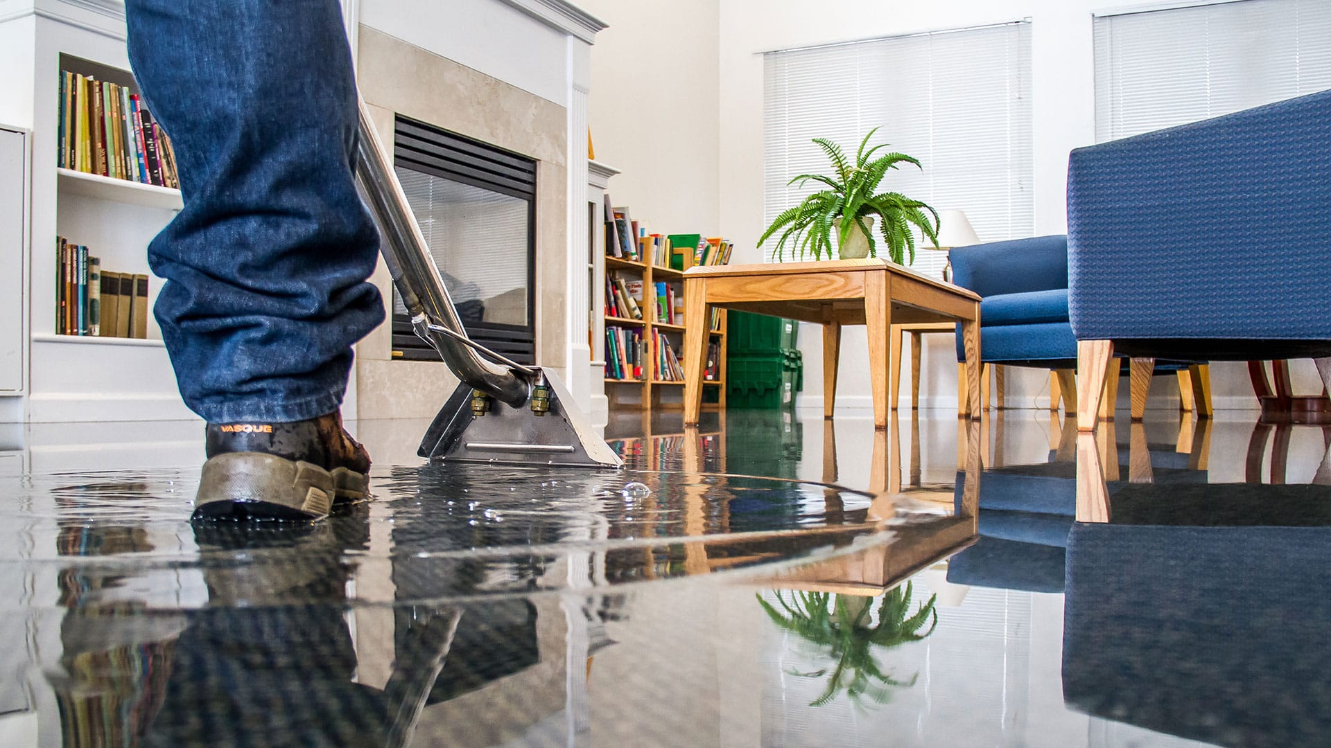 A technician extracting water from a residential living space